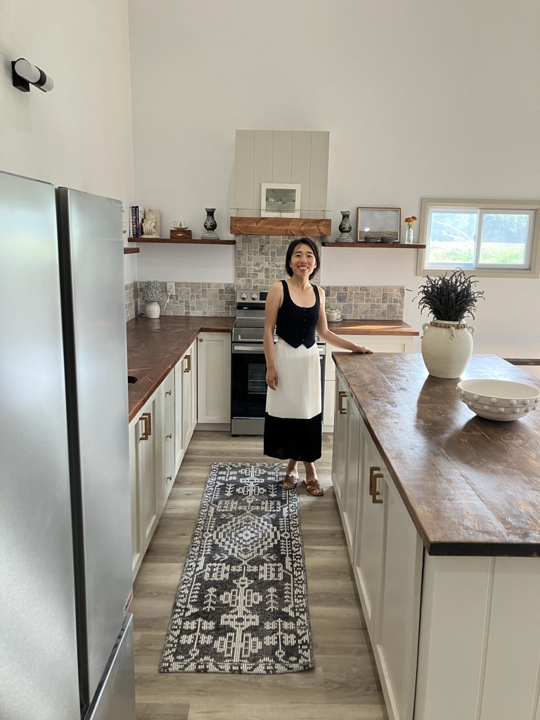 Owner standing in the hand-built kitchen